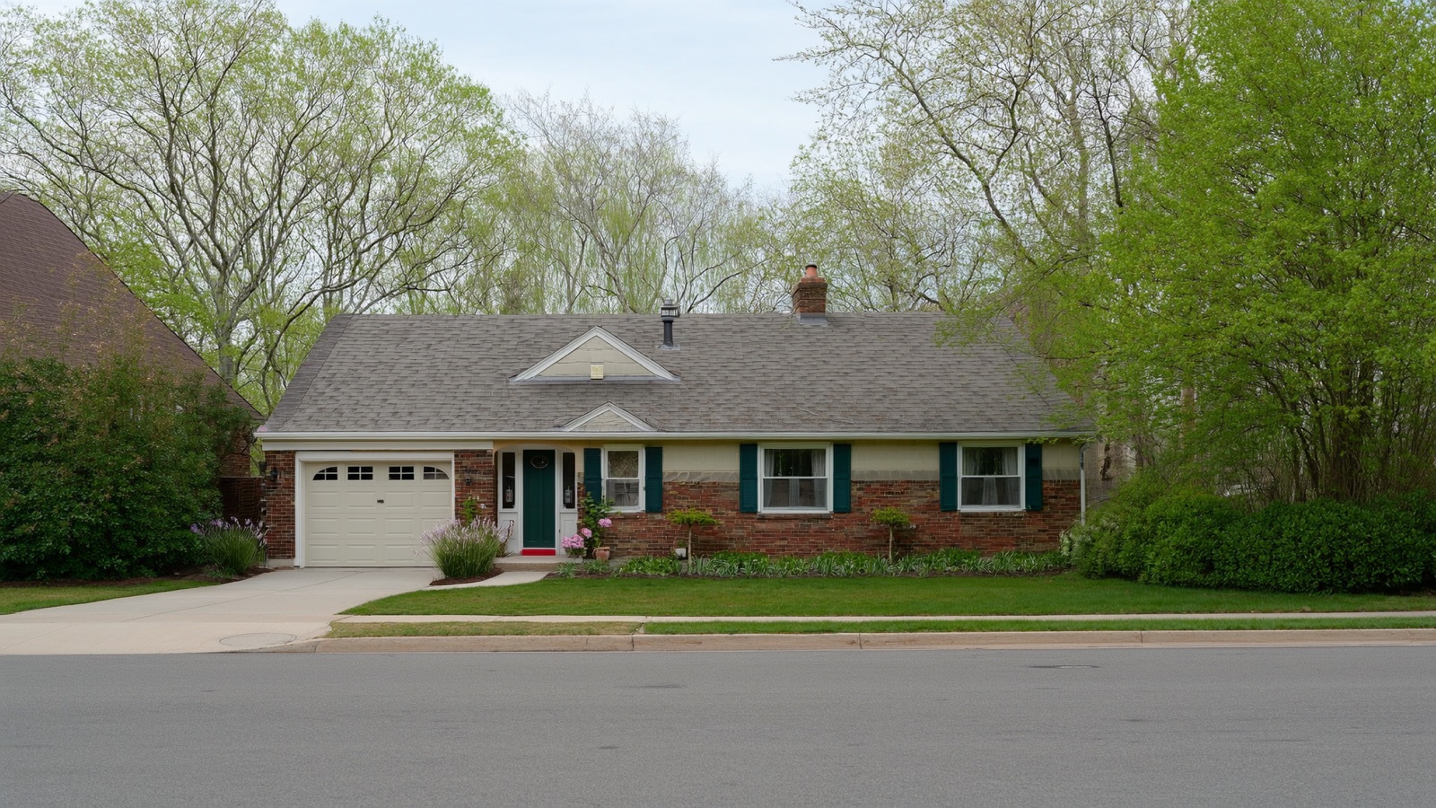 Suburban Minnesota starter home on a leafy residential street in spring