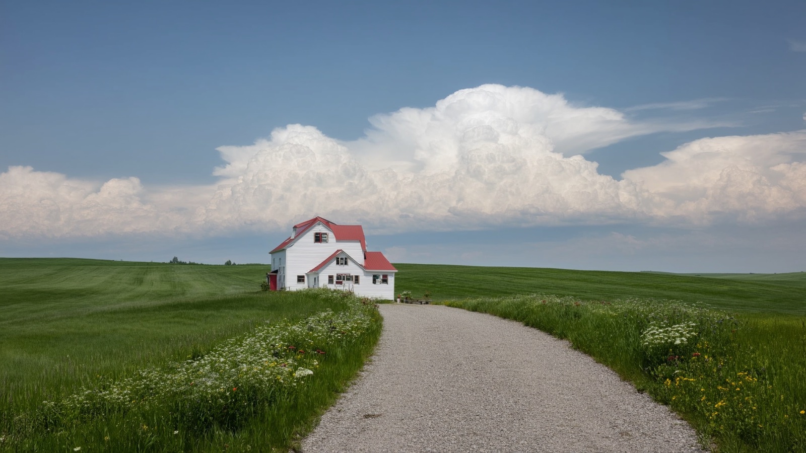 White farmhouse and red barn on rolling Wisconsin countryside